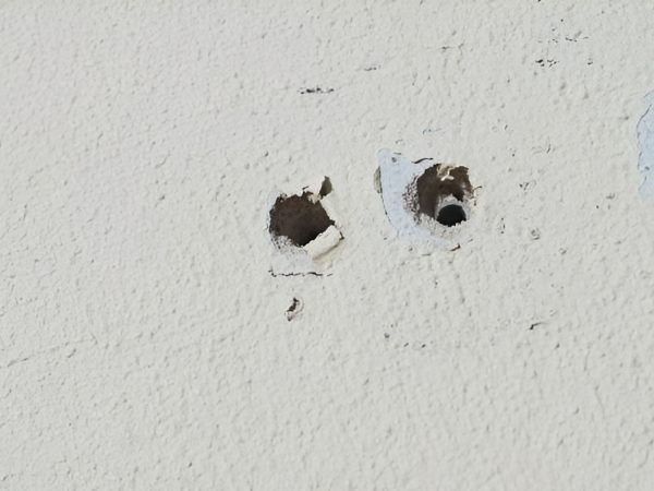 two small drywall anchor holes